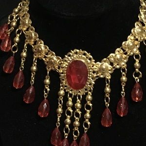 Gold- toned chocked with dangling Red Rhinestones